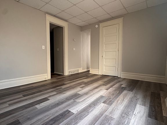 living room, bathroom door on left, hall to kitchen, bedroom door