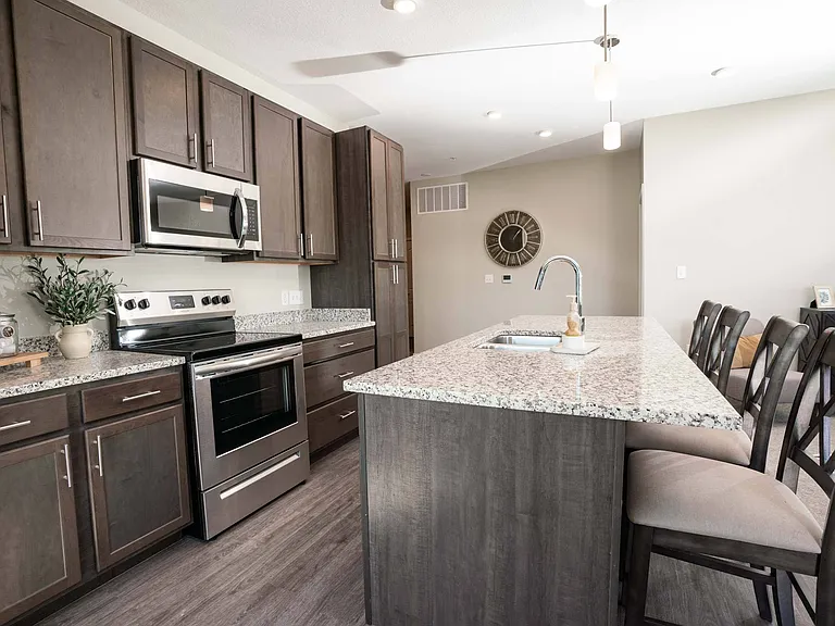 Luxury kitchen with stainless steel appliances at Heartland Flats Alliance.