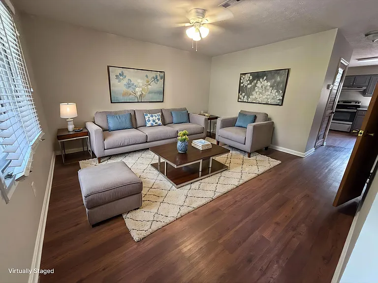 Elevate your lifestyle at Guest House with this inviting living space featuring warm wood floors and stylish decor. Relax in comfort or entertain with ease. Explore our available homes today and find your perfect fit.