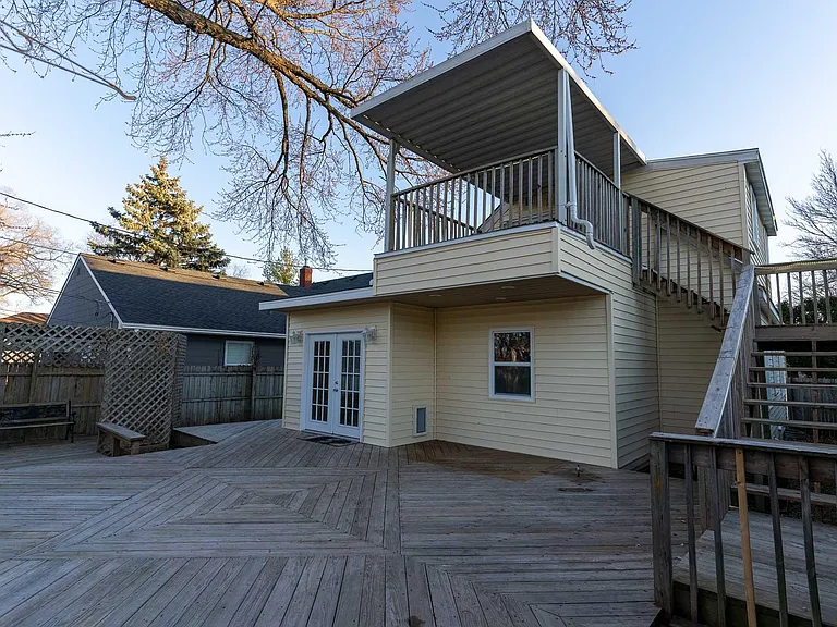 Stairs at the back of house to upper unit.