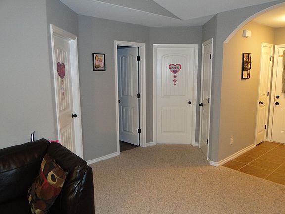 View of bed2&3 doorways, Guest Bath middle door.  From Living