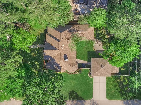 Aerial view - beautiful wooded lot. Detached garage, separate storage shed and raised garden in back corner of lot.