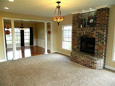 Living Room. Upon entering, has nice living room w/wood-burning fireplace. Open-floor plan continues to Dining Rm.