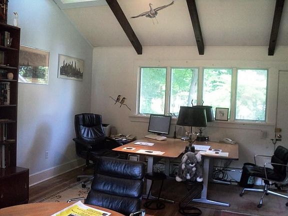 Den with vaulted Ceiling and Hardwood Floors