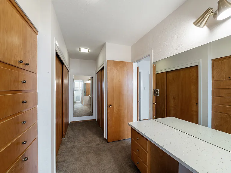 Primary bedroom closet and dressing area.