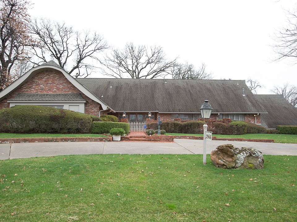 Lovely  exterior with a courtyard entry, circle drive and rear entry garage.