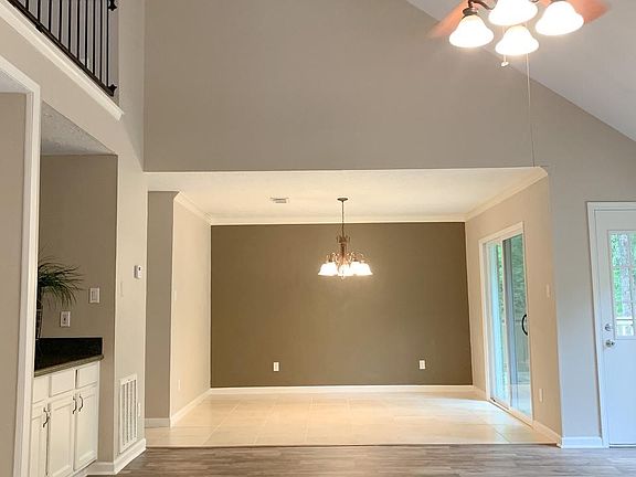 View of formal dining/upstairs area from family room. Great built-in storage area (on left) and/or can use for a bar type area too.