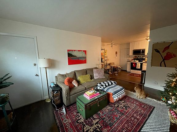 living area opens to dining area and kitchen partial