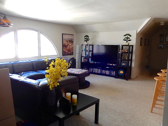 Large Living room has fabulous, large antique "fan" window.
