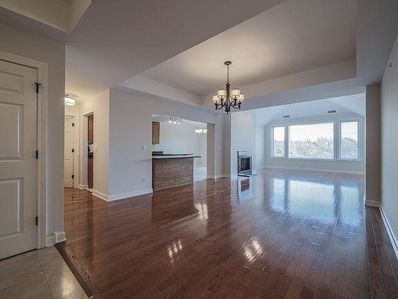 View of Dining and Great Room from Den. This 10 x 12 den can be used as an office; quasi extra bedroom, TV room, other.