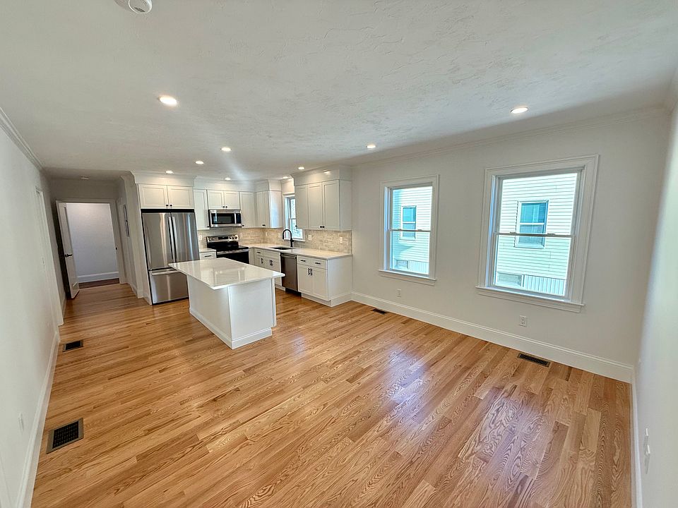 Welcome Home to Unit 1 at 34 Saint Joseph! Enter into Kitchen: Brand New Stainless Steel Appliances, Quartz Countertops with Open Layout into Living Area