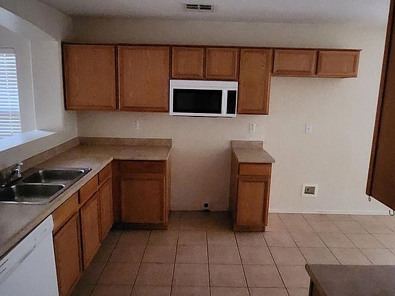 This is a current photo of the Kitchen. NEW stove and refrigerator will be installed prior to move in.