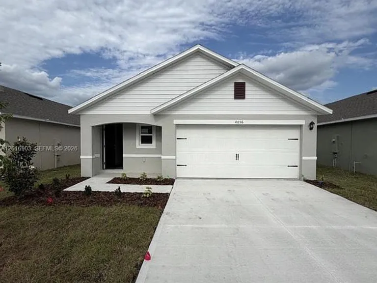 Single-story home with a covered entry, two-car garage, and wide driveway plus a low-maintenance front yard.