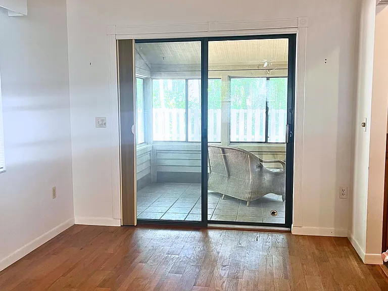 Sliding door to exit living room and enter sunroom