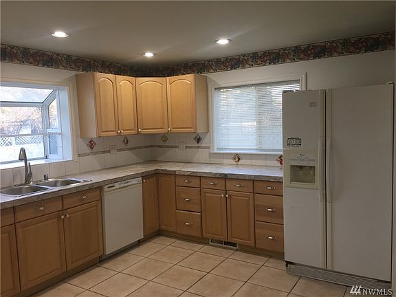 Light-filled kitchen with garden window and southerly facing window, both over looking the backyard.