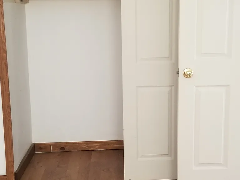 Apartment bedroom with view of empty closet