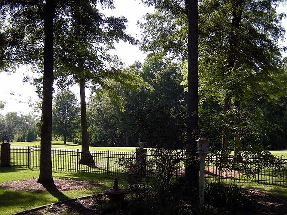 Lush, mature landscaped backyard overlooking 14th fairway