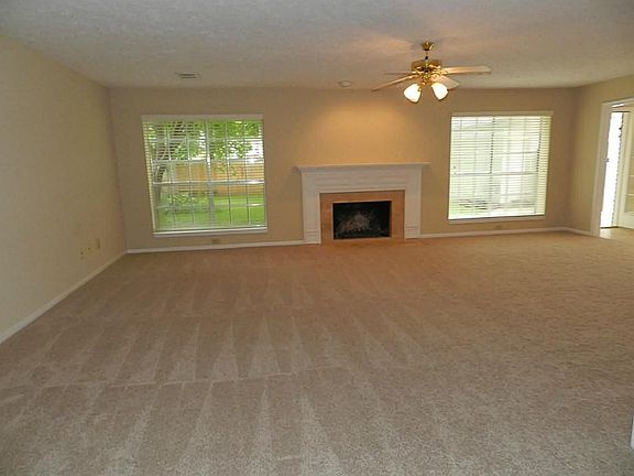 Very large den or family room with two great windows over looking the back yard.  Note the fireplace with marble accent, wood mantle and gas pipe to make it easier to start a warm fire in the winter time.