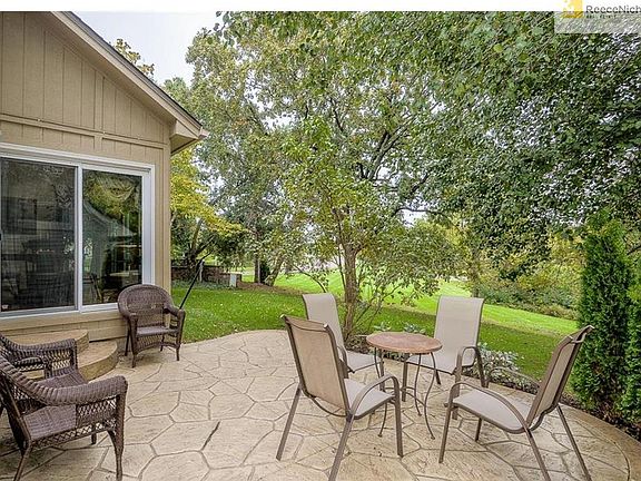 Enjoy the scenery with green space that lead to trails on new concrete stamped patio.