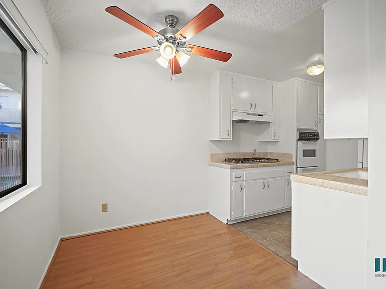 Kitchen and Dining Room with Ceiling Fan and Windows