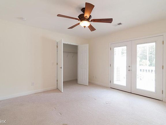 Master bedroom #1 with covered deck through the French doors