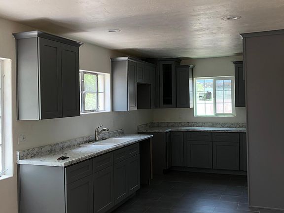 Full Kitchen with lots of cabinet space. All white appliances. Dishwasher and side by side fridge.