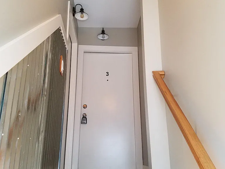 Going up the steps to your apartment door. Apartment door is at the top of the stairs to the left.