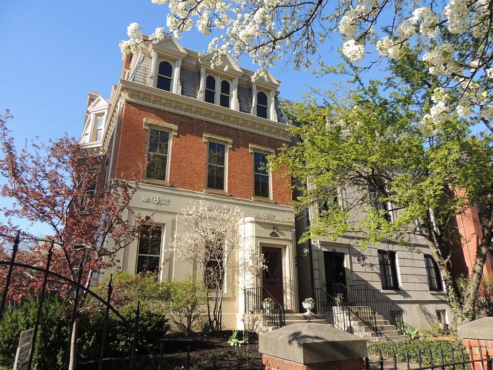 Historic Lazarus Mansion with spring-blooming trees