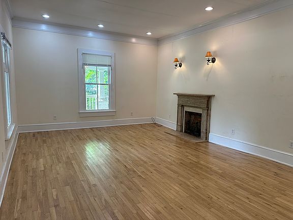 banquet size living room with 10 foot ceilings and hardwood floors