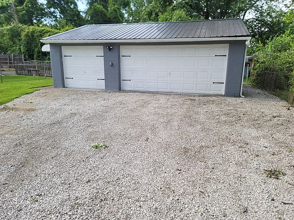 Deep three-car garage with new door operators and metal roof, 220-volt electric service.