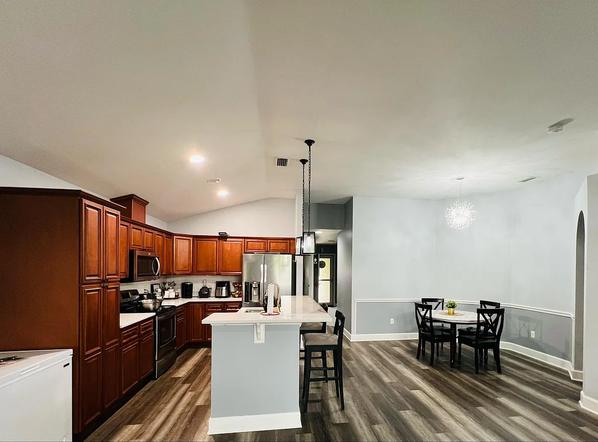 Open kitchen with modern and fully equipped, and sleek countertops, high-end appliances - 3602 NW 55th Ln #3