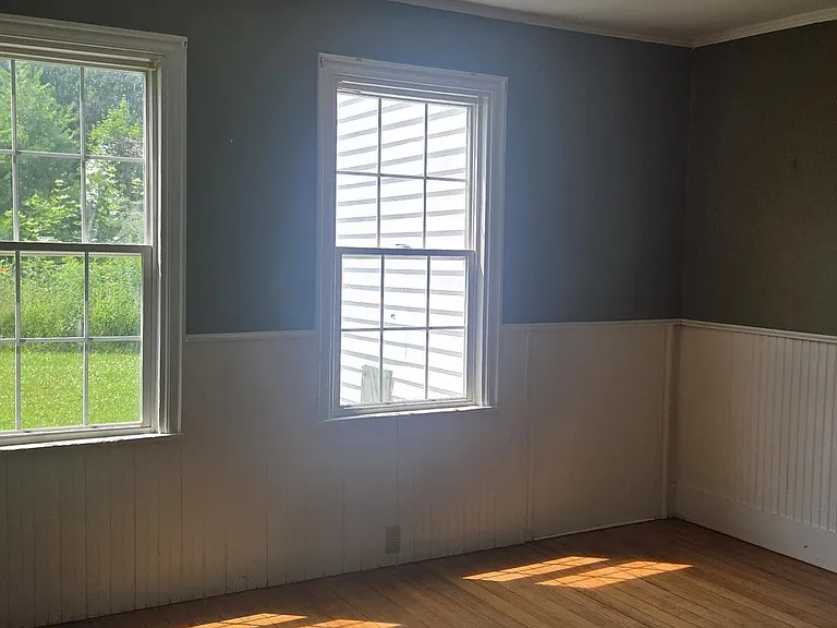 Dining Area With Hardwood Flooring and Wainscoting. Let In Lots of Natural Lighting and Private Back Yard