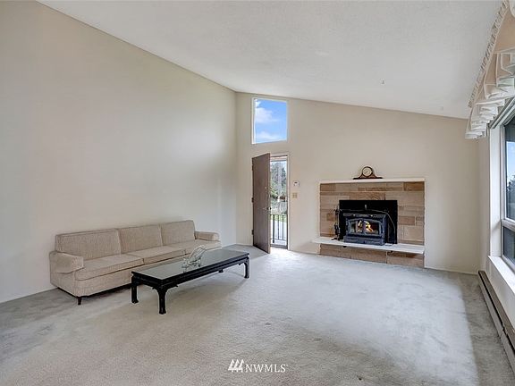 Host gatherings with room to spare in this large living room, with wood-burning fireplace providing plenty of warmth and ambience.
