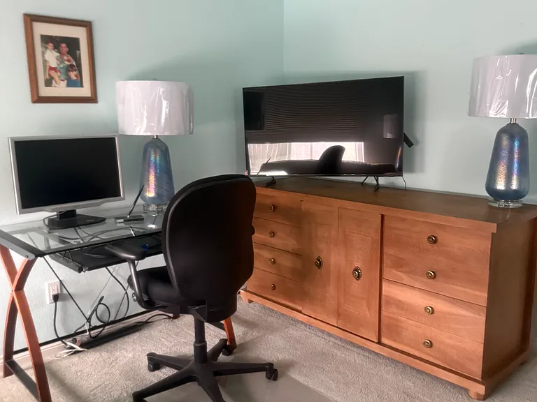 Primary bedroom's dresser area and office