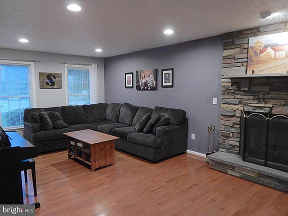 Living Room w/stone front fireplace, wood floors