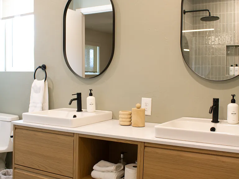 Spacious double-sink bathroom with modern fixtures and generous storage_ideal for shared living.