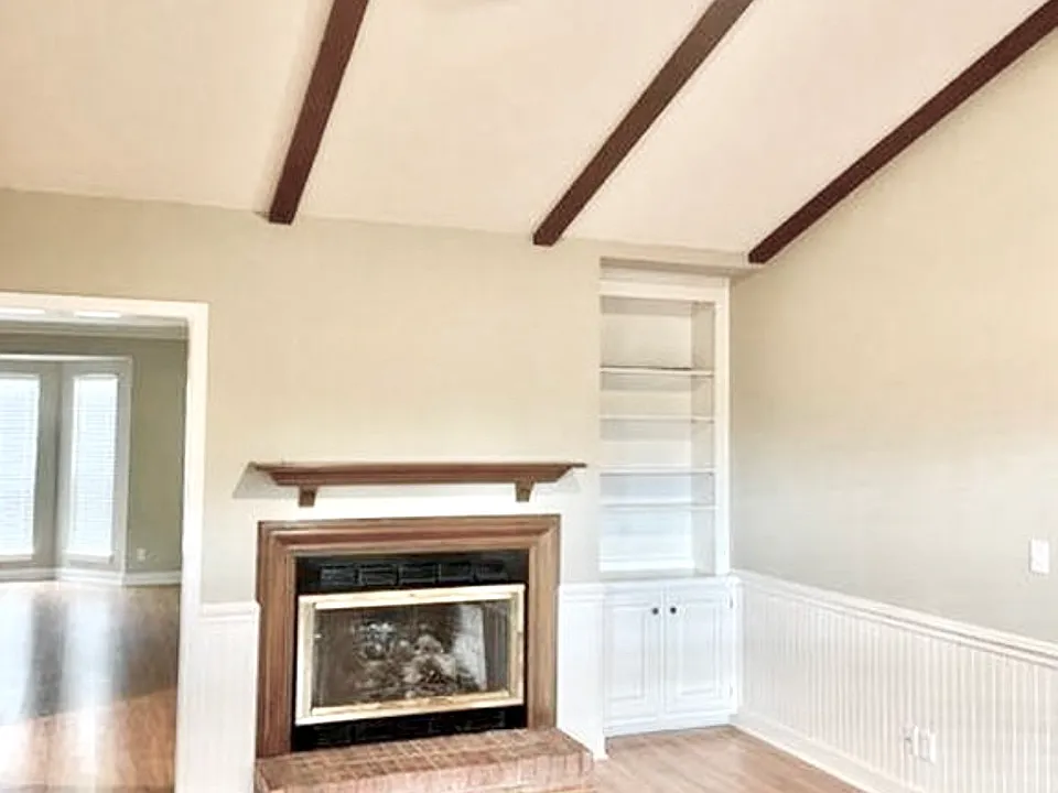 Open and Vaulted Den with Gas Fireplace. Hardwood floors throughout.