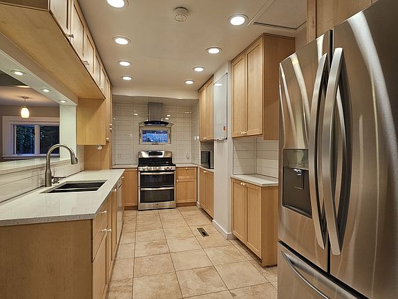 Generous kitchen with ample cabinet space and LG refrigerator.
