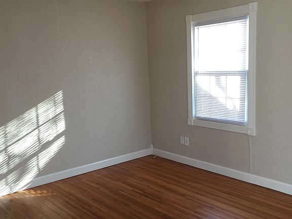 Light and bright living room with hardwood floors, lots of windows (insulated replacement windows).