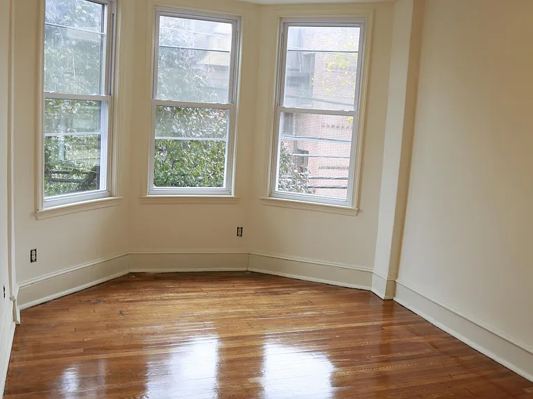 living room, bay window, ceiling fan, and lights. hardwood. bright room.