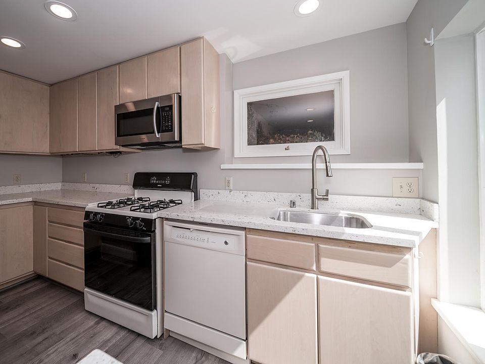 Light-filled kitchen with quartz countertops (note: corner cabinet since rejiggered to incorporate some open shelving)