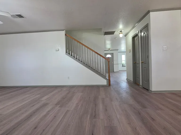 Living area looking into stairs, mini closet, and half bathroom