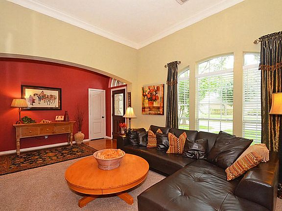 THE ENTRY FEATURES WOOD FLOORING! THE LIVING ROOM FEATURES CUSTOM DRAPERIES!