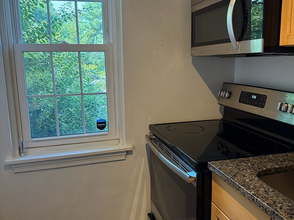 Kitchen with stainless steel stove and microwave
