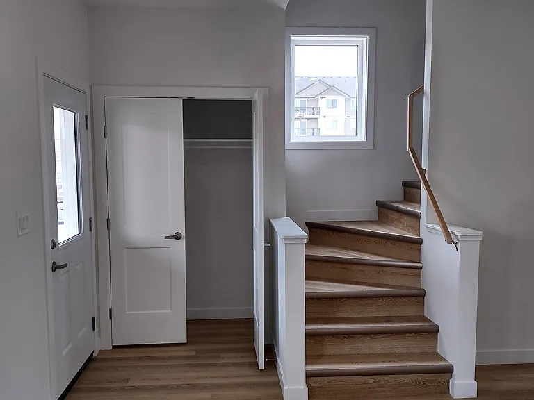 Front door entrance with Coat closet and staircase