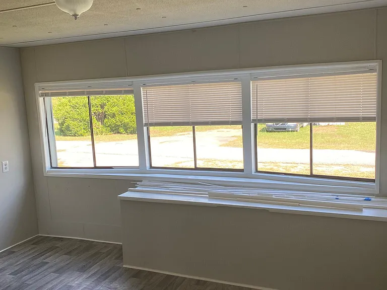 Master bedroom with plenty of window for a cool breeze or morning light.