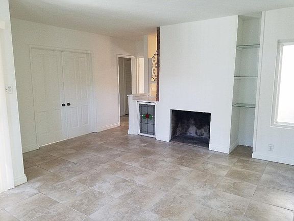 Large living room with porcelain tile flooring thru out.  