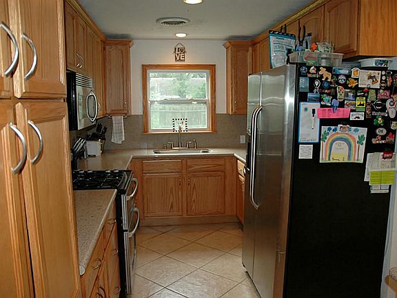 Updated Kitchen with Silestone counters, gas cook top, under mount sink and stainless steel appliances.