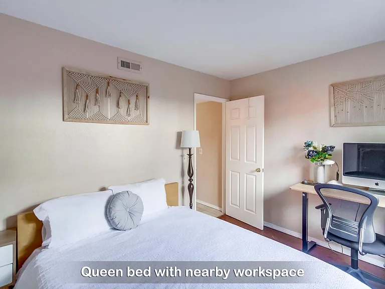Here's comfy queen bed in Bedroom 3 with a nearby workspace to catch up on work