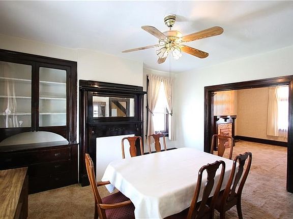 HUGE 14x13 Formal Dining Room featuring Beautiful Woodwork on Decorative Fireplace & Built-in China Cabinet w/ Drawers. Gorgeous